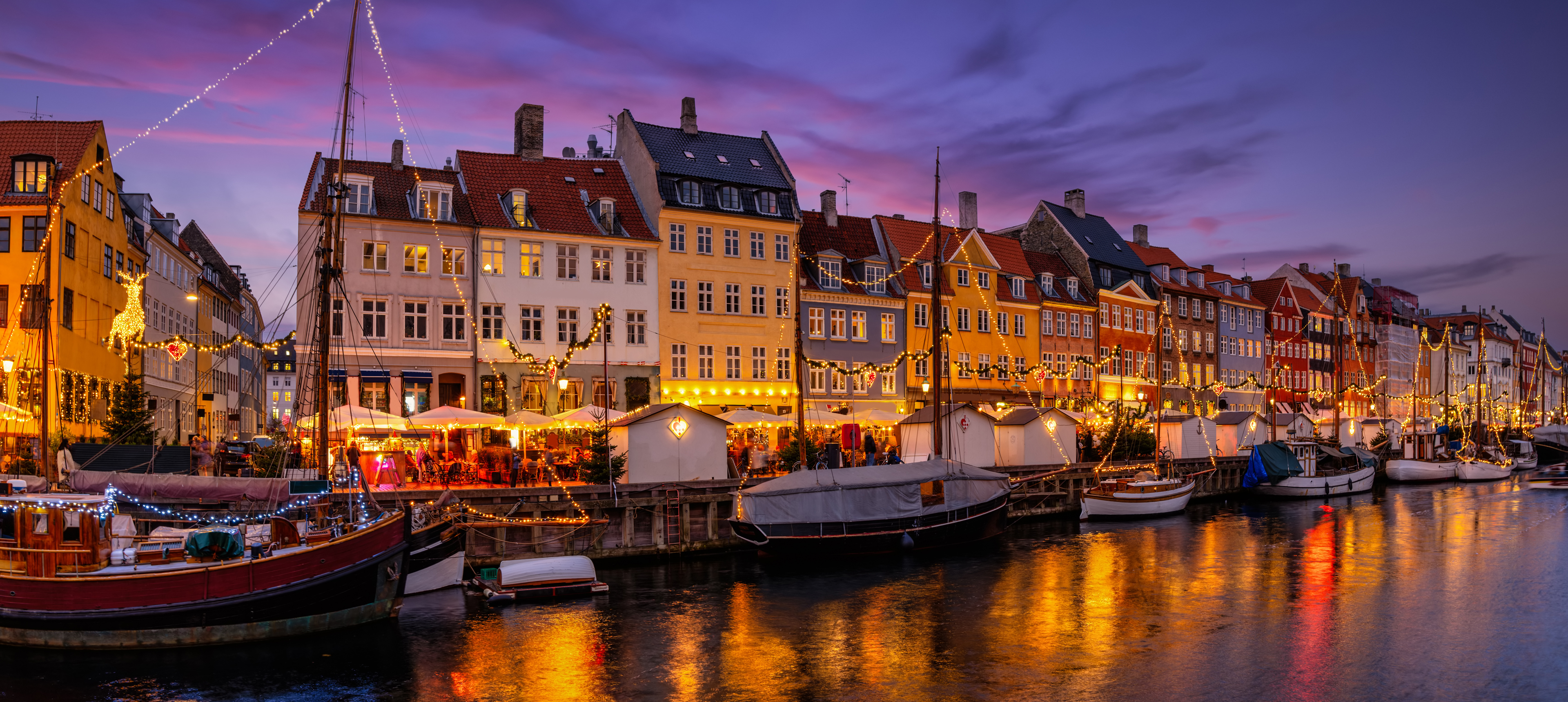 Beautiful winter evening view of the popular Nyhavn area at Copenhagen, Denmark, decorated for Christmas time